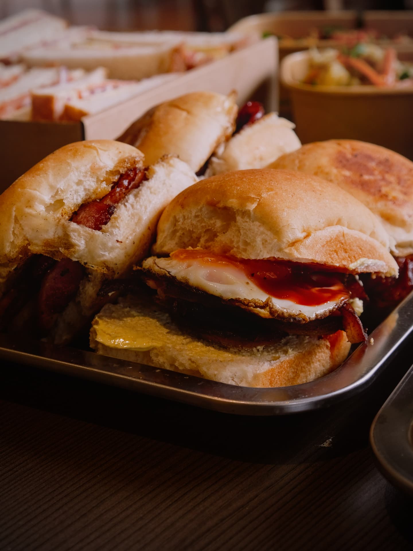 Bacon and egg breakfast rolls on a tray for an on-set catering crew.